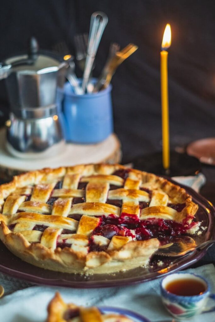 pie on table with candle behind it 