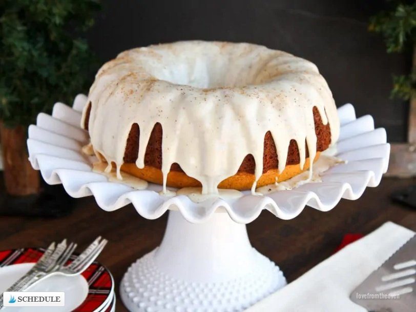 eggnog bundt cake with glaze on top on a cake stand 