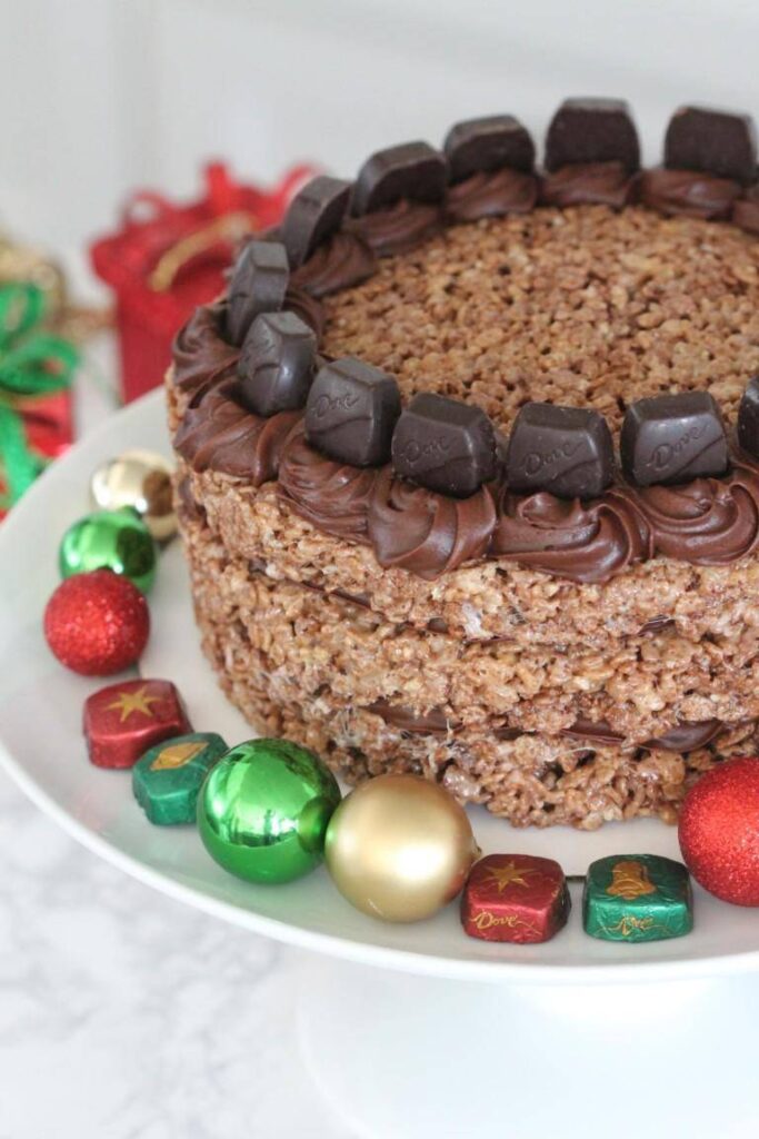 layered chocolate rice krispies treat with ornaments and candy around it 