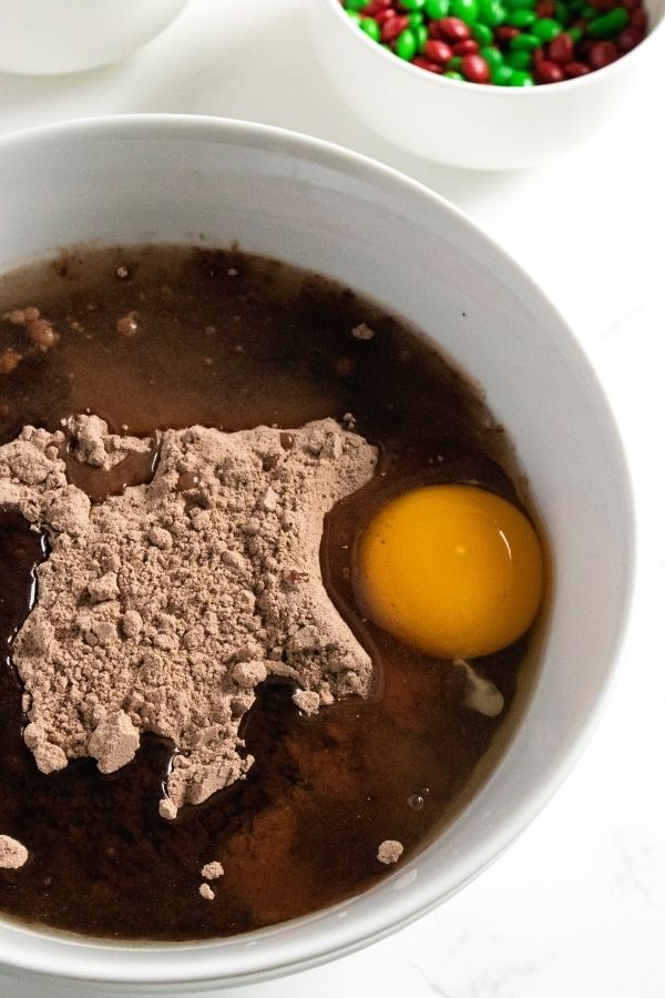 bowl with brownie mixture in it with eggs 