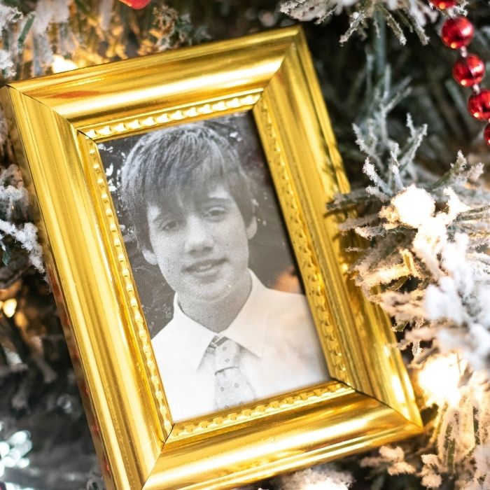 gold picture frame with picture in it on tree 