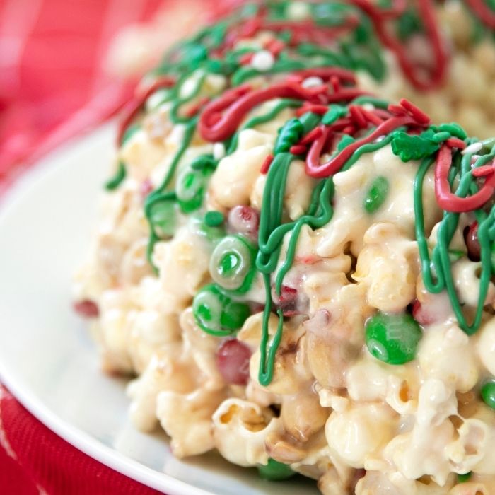 Christmas Popcorn Cake is a marshmallow and popcorn cake that is sweet and salty. A no-bake Christmas cake that is tasty and simple to make. #passion4savings #christmas #cake #popcorn #easy #best #nobake #sweet #salty #easydessert #holiday close up of a popcorn cake