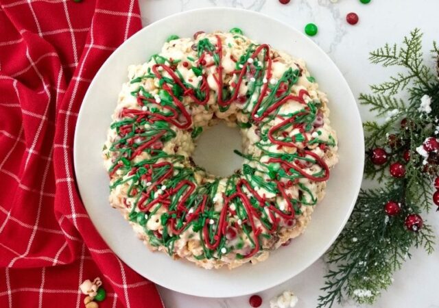 popcorn cake on platter drizzled with festive chocolate