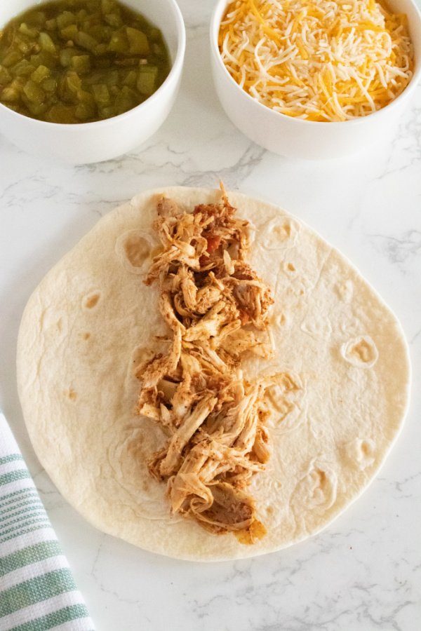 tortilla with shredded chicken in middle