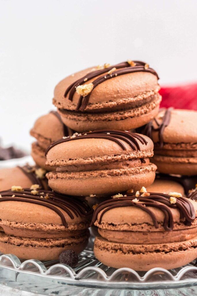 stacked chcolate macaroon cookies on plate