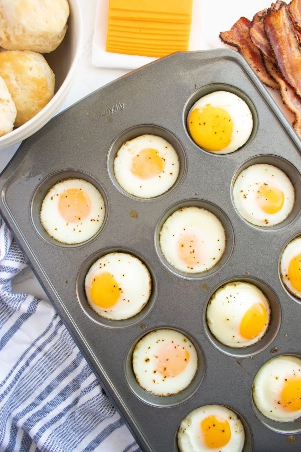 Learn How to Make Freezer Breakfast Sandwiches! These are great for meal prepping or stocking your freezer for breakfast for the whole family. #passion4savings #breakfast #mealprep #makehead #freezer #freezerfriendly #sandwich #breakfastrecipe #easy #tasty #delicious cooked eggs in a muffin tin