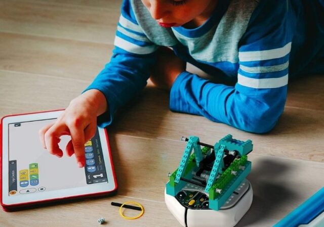iRobot Root Coding Robot - boy using coding robot