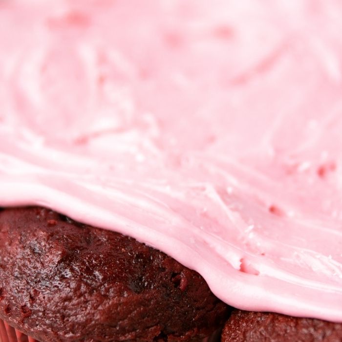 close up of cupcakes with pink frosting on top