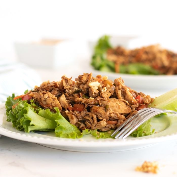 Whip up these easy teriyaki chicken lettuce wraps! Shredded chicken, teriyaki sauce, served on crisp lettuce. A simple lunch or dinner. #passion4savings #teriyaki #chicken #shreddedchicken #easy #dinner #lettucewraps asian teriyaki chicken on lettuce in box
