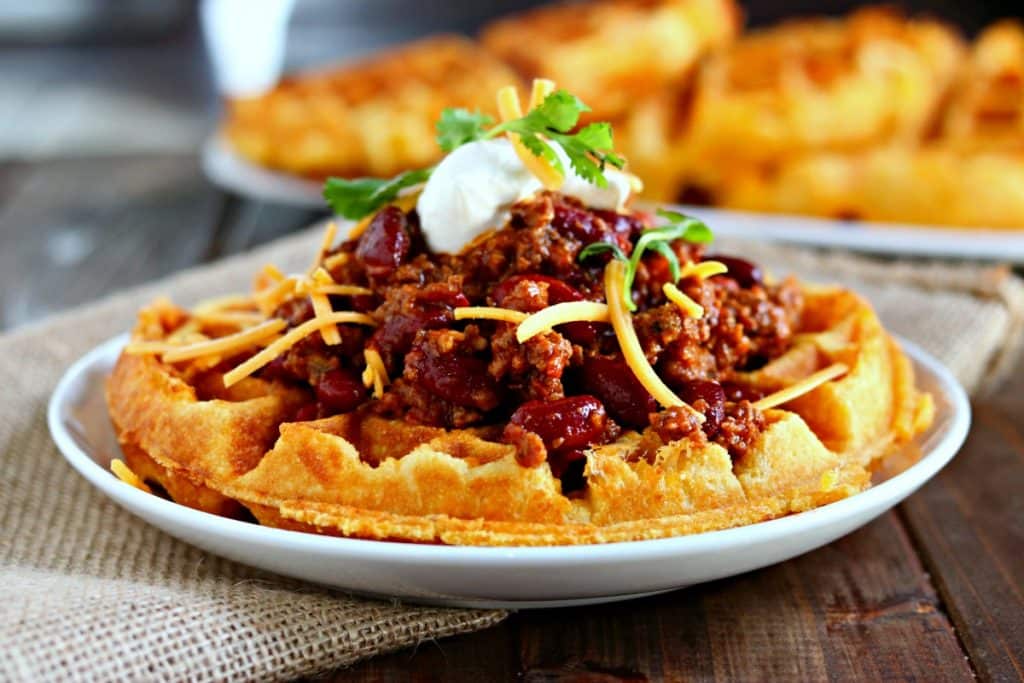 Check out these tasty recipes in waffle maker! From sweet to savory and all things in between. Whip up these for snacks, lunch or dinner. #passion4savings #waffle #wafflemaker #savory #sweet #dessert #best #easy cornbread waffles with meat and cheese on top