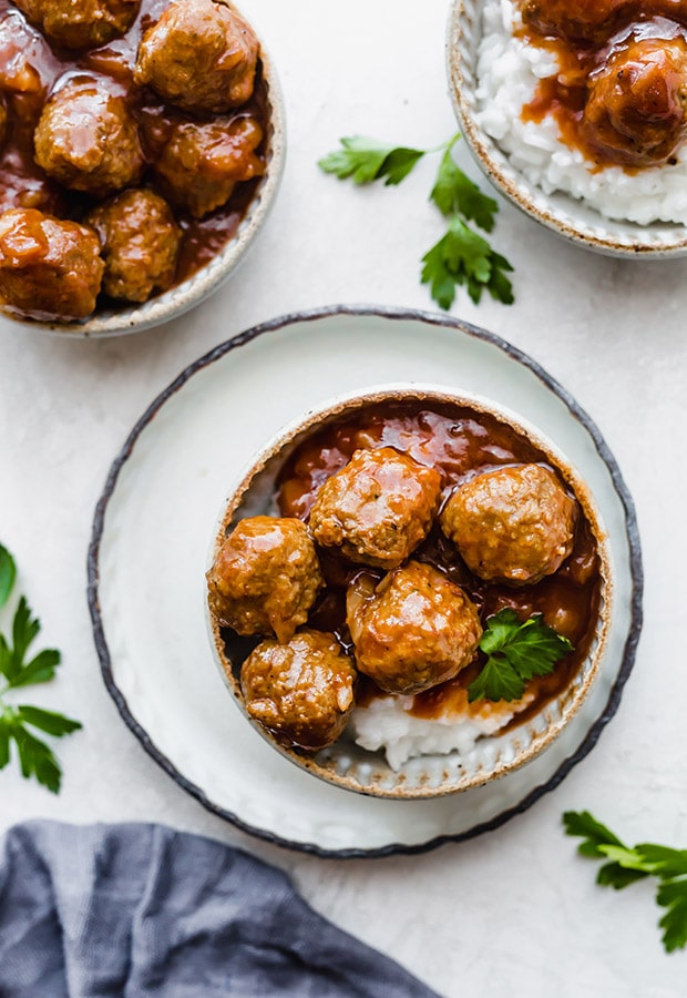 meatballs in a bowl with rice under it 