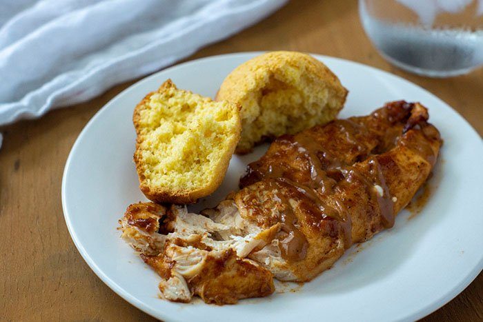 BBQ Ranch chicken on plate with cornbread