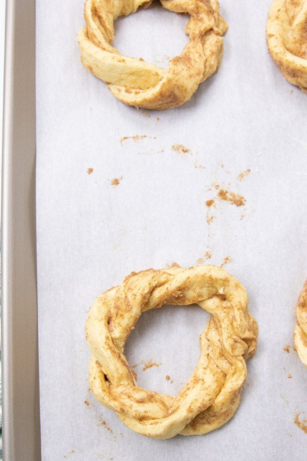 cinnamon rolls in a twisted circle on baking sheet 