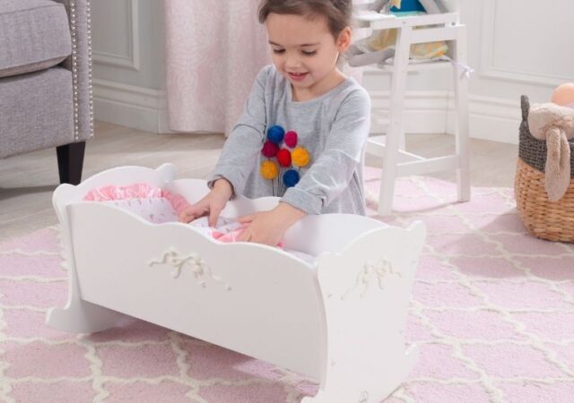 KidKraft Doll Cradle on Sale - girl playing with doll cradle