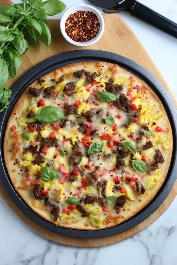 ground sausage pizza in pan on table 