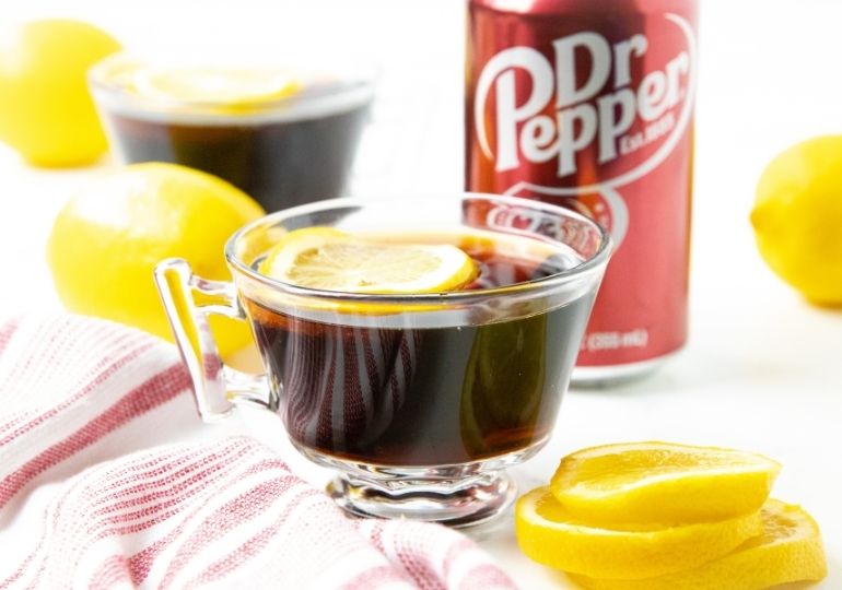 hot doctor pepper in clear mug with lemons by it