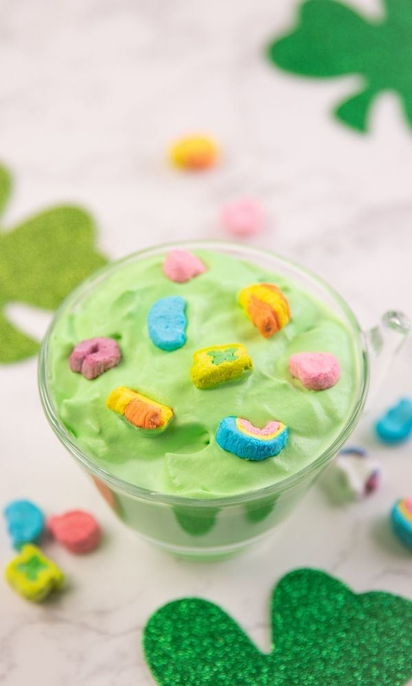 hot chocolate for st patrick's day on table with shamrocks 