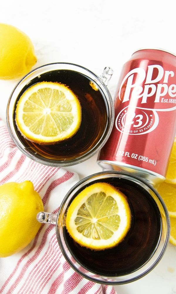 cups of dr pepper with lmeon with a can of pop on counter
