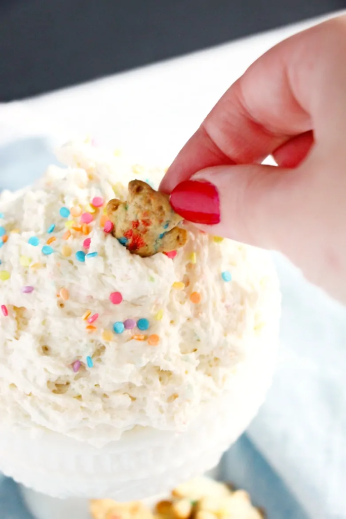 cake batter dip with teddy graham dipping in it 