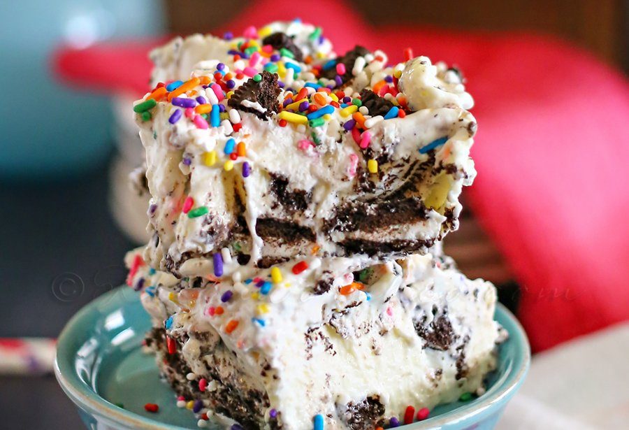 Oreo cheescake cake batter bars stacked on plate 