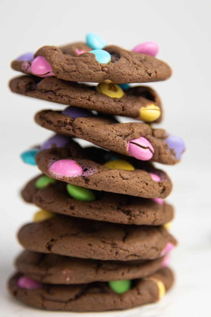 Easter Cookies in a Jar Gift is a fun Easter gift to send to loved ones. This Easter M&M Cookie in a jar is so easy and fun to make. #passion4savings #easter #printable #easterrecipe #cookies #eastertag #masonjar #gift #affordable chocolate cake mix cookies stacked on top of each other