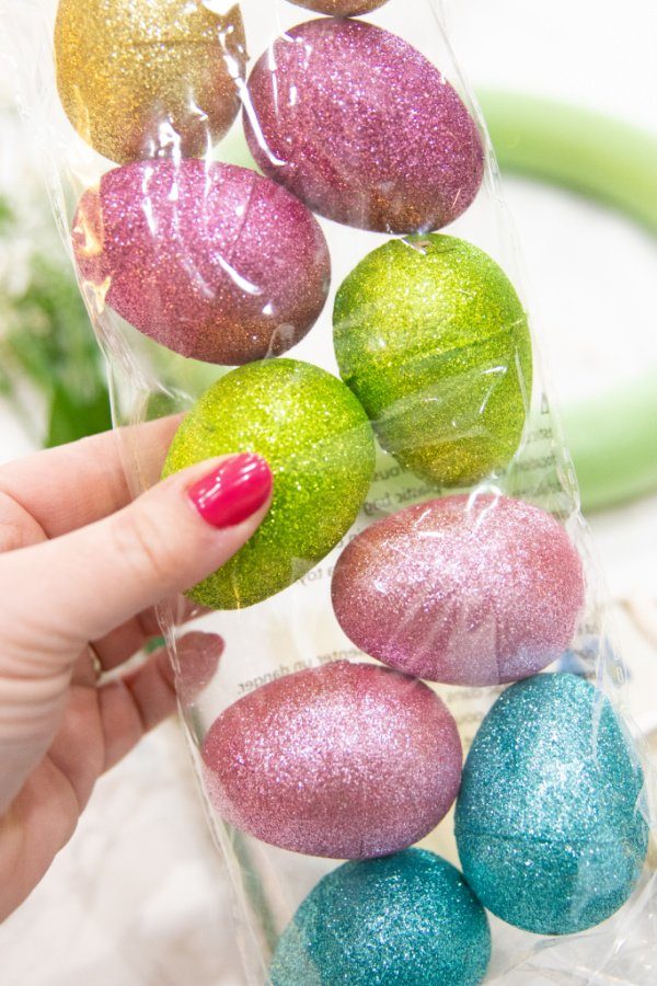 Dollar Tree Easter Egg Wreath is a simple and easy fun Easter Wreath you can make with all the supplies from the Dollar Tree. #passion4savings #easter #wreath #egg #plasticegg #dollartree #affordable #budget easter egg craft idea