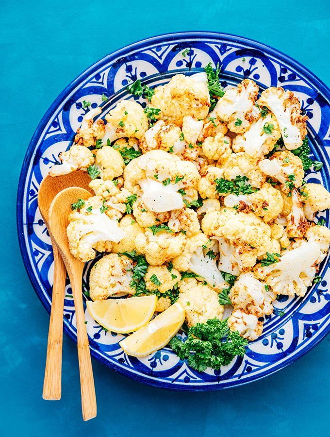 cauliflower in a bowl with spoons 