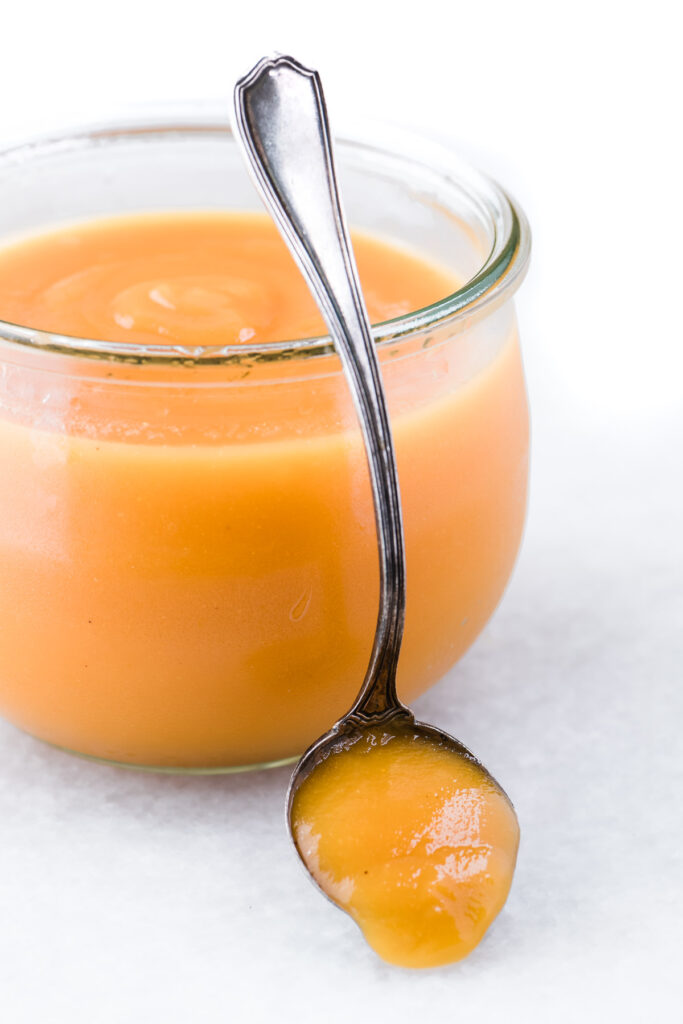 peach butter in a jar on table