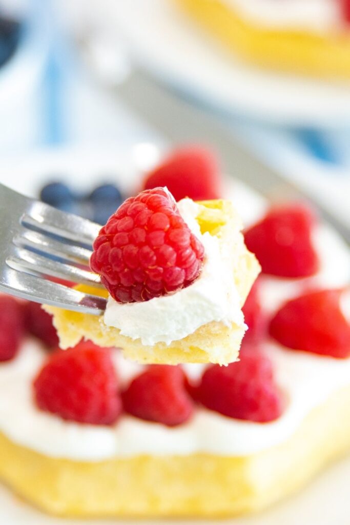 Patriotic Flag Waffles are the perfect 4th of July breakfast recipe. Or if you want a memorial day recipe, try this fruit and waffles. A great breakfast for kids or adults. #waffles #breakfast #patriotic #4thofjuly #whippedcream #fruit #wafflerecipe #forkids waffle with whipped cream on it