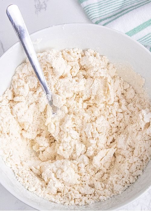biscuit dough in a white mixing bowl