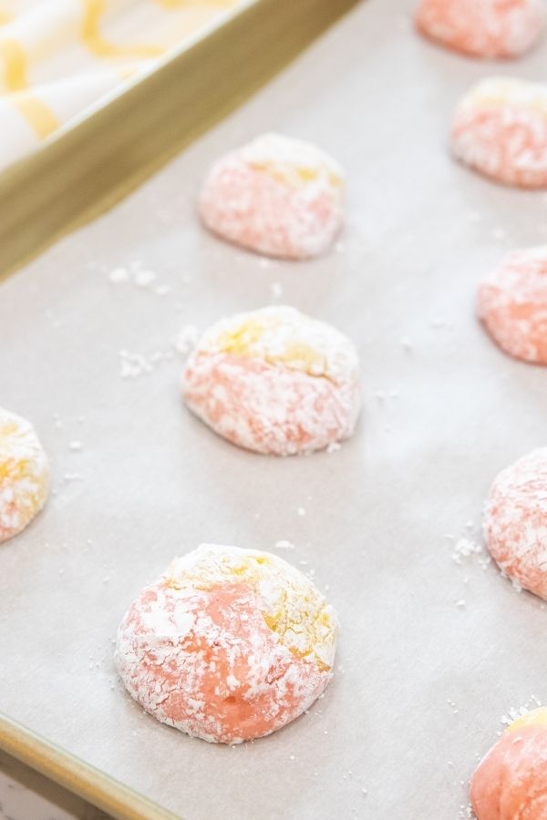 Whip up these simple strawberry lemonade cake mix cookies. A summer cookie that is swirled with strawberry and lemon flavor in each bite. #passion4savings #cakemix #cookies #best #strawberry #lemonade #bake #baking #cakemix #cookierecipe cookies on baking sheet