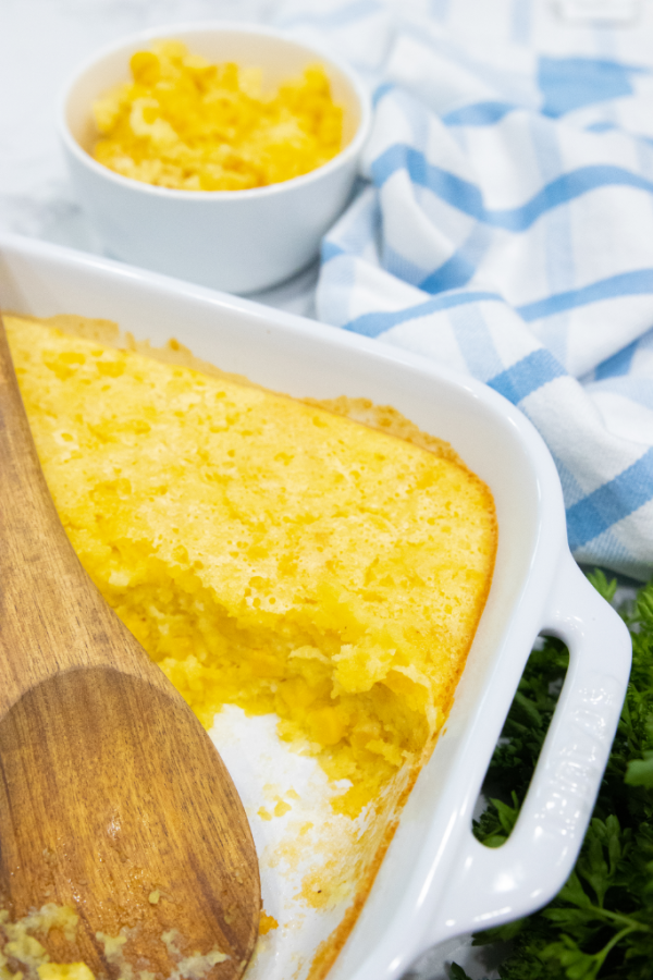 scoop of corn casserole in pan 