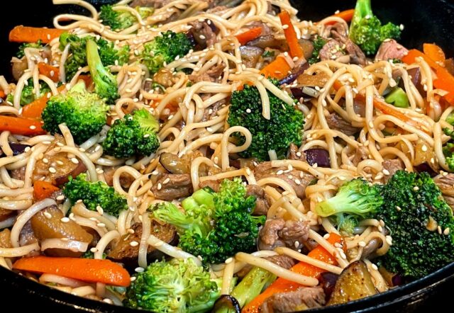 udon stir fry in a skillet on stove 