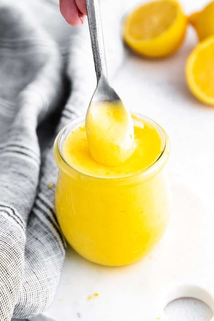 lemon curd in a jar with spoon 