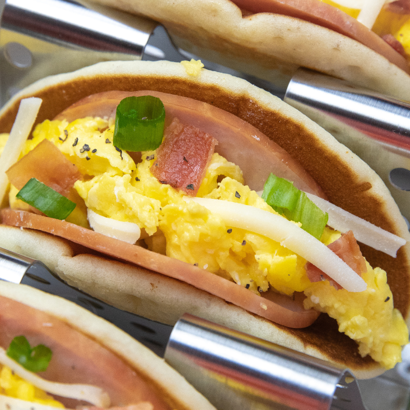 Pancake breakfast tacos are an easy and delicious way to kickstart your day. These pancakes tacos are so simple to make and delicious. #passion4savings #tacos #breakfast #recipe #easy #simple #quick #pancake #frozenpancakes breakfast tacos in a tray