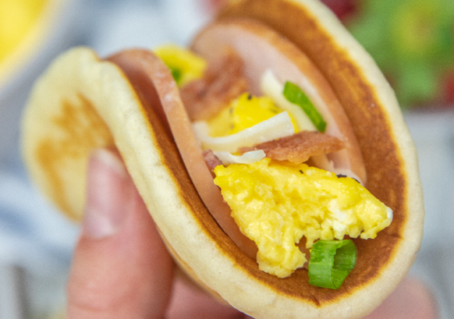 holding a pancake taco in hand