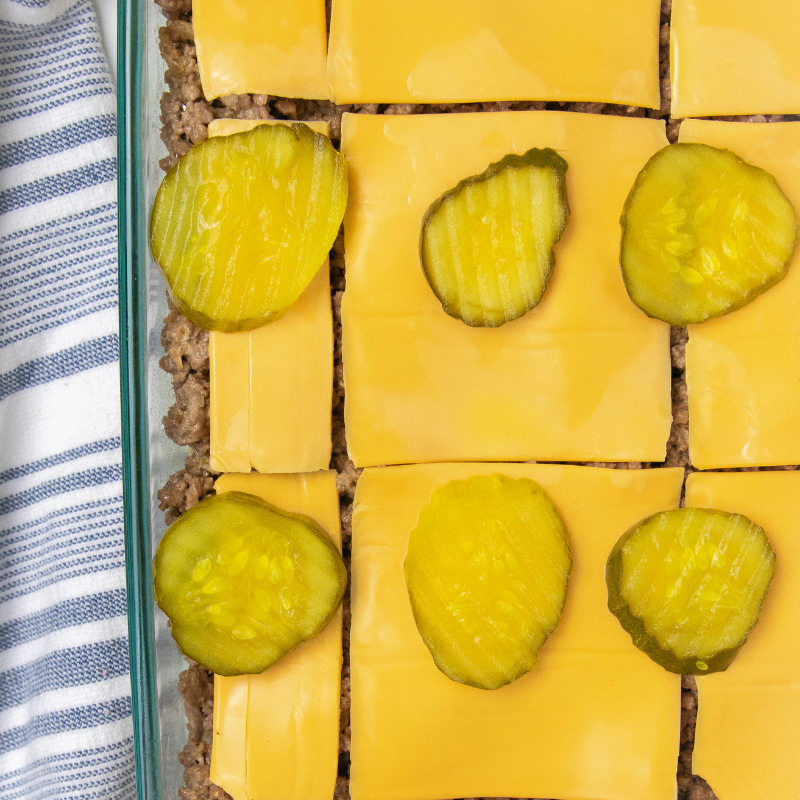 cheeseburgers with pickles on top 