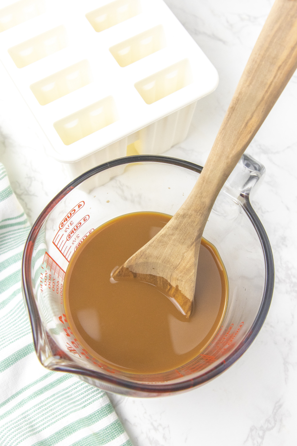 coffee and cream mixed in a measuring cup
