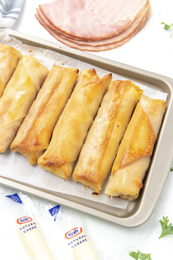 deli ham and cheese sticks on baking tray 