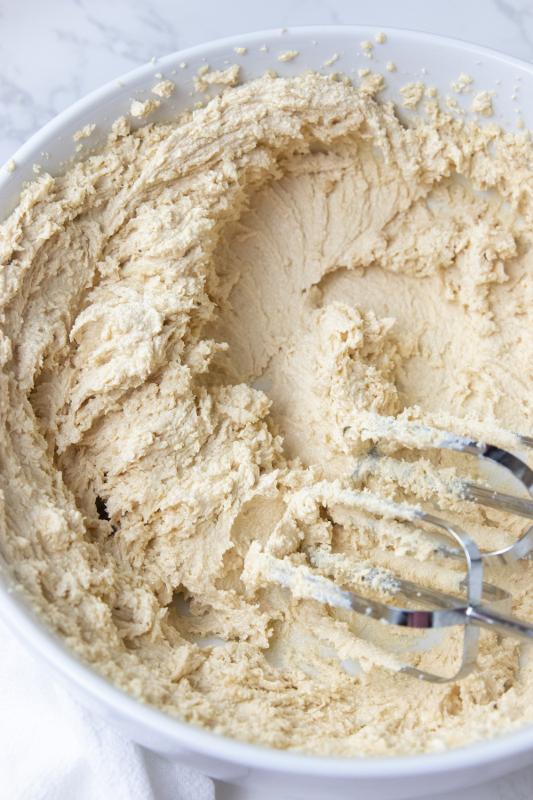 Reese's Peanut Butter Cup Edible Cookie Dough is a delicious and easy dessert for you to try out. This cookie dough has no eggs. #passion4savings #eggs #cookiedough #easy #reeses #peanutbutter #peanutbuttercups #edible #noegg cookie dough in a bowl with mixers