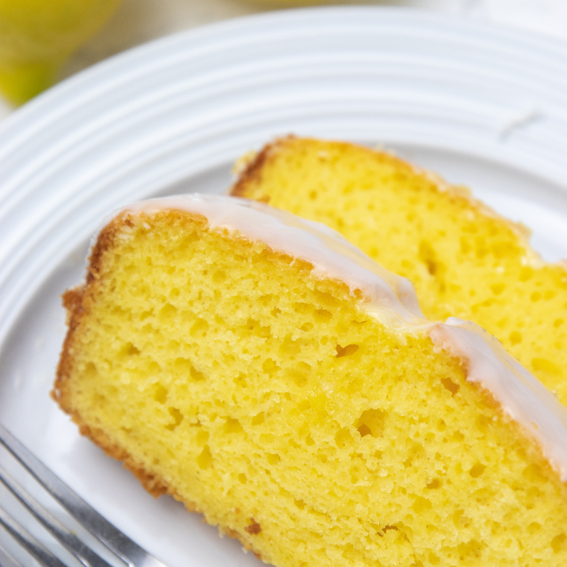 Starbucks copycat lemon bread is a delicious lemon bread with a homemade 2 ingredient lemon glaze. A Starbucks recipe to make at home. #passion4savings #lemon #bread #lemonloaf #lemonbread #lemonglaze #starbucks #copycat #recipe siced lemon bread on plate with fork by it