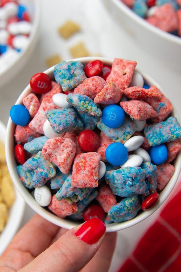 holding a bowl of puppy chow in hand 