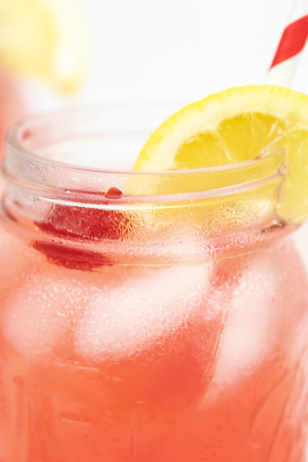 Cherry lemonade is a refreshing and simple fruit lemonade that takes just 2 ingredients. Give this simple drink a try today. #passion4savings #cherry #lemonade #2ingredients #easy #summer #refreshing #simple #tasty lemonade in a jar with lemon slice