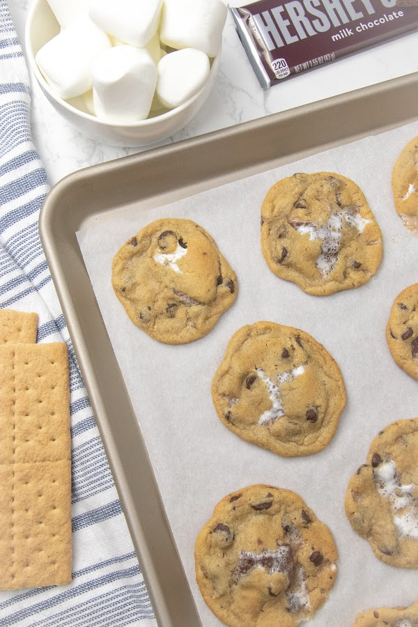 cookies on baking sheet with graham crackers by it 