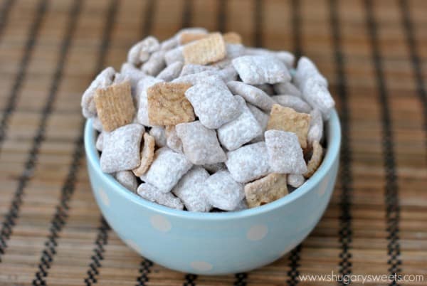 cereal snack mix on blue bowl on wooden table 
