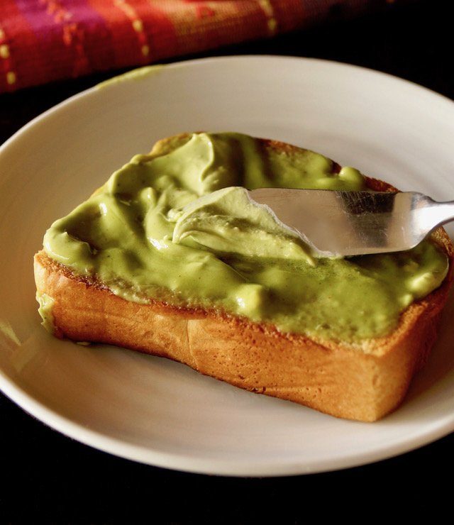 creamy avocado butter on bread with knife 