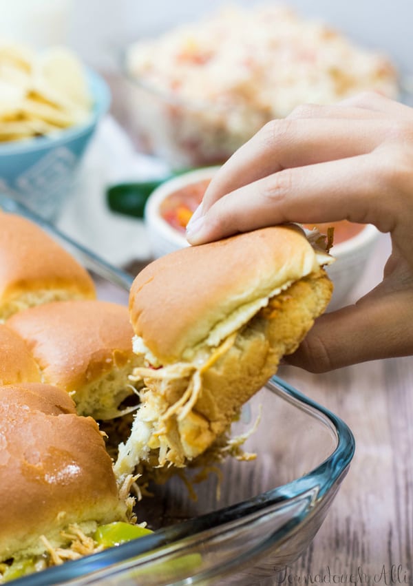 chicken fajita slider being lifted out of baking pan