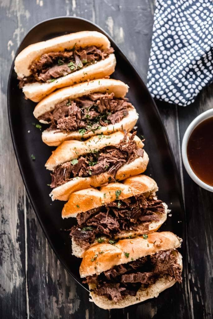 French dip sliders on a platter on table