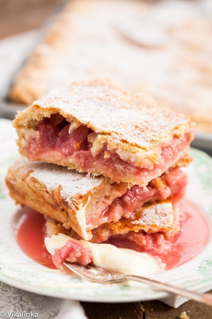 sliced rhubarb pie in squares stacked on plate
