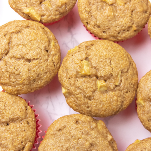 counter with apple muffins placed by each other